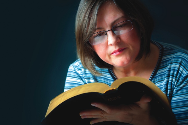 A woman reading a Bible.