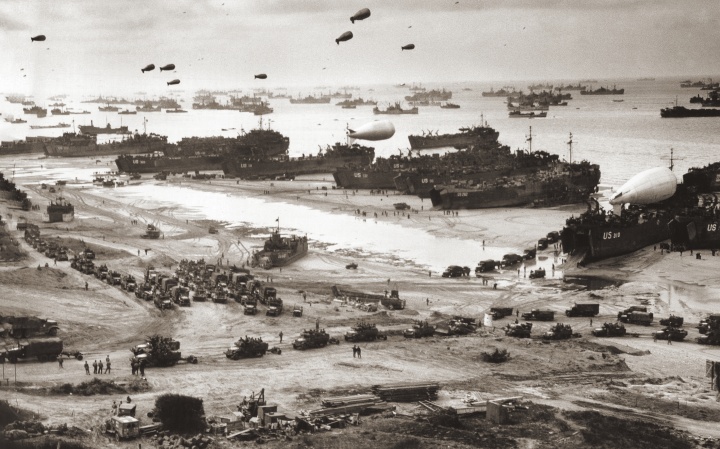 With the Normandy beachhead secured, vast numbers of Allied troops and military vehicles flood ashore.