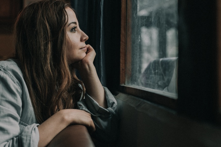 A woman looking out a window.