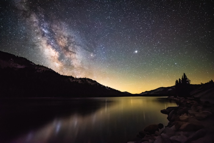Starry night over lake with Milkyway galaxy.