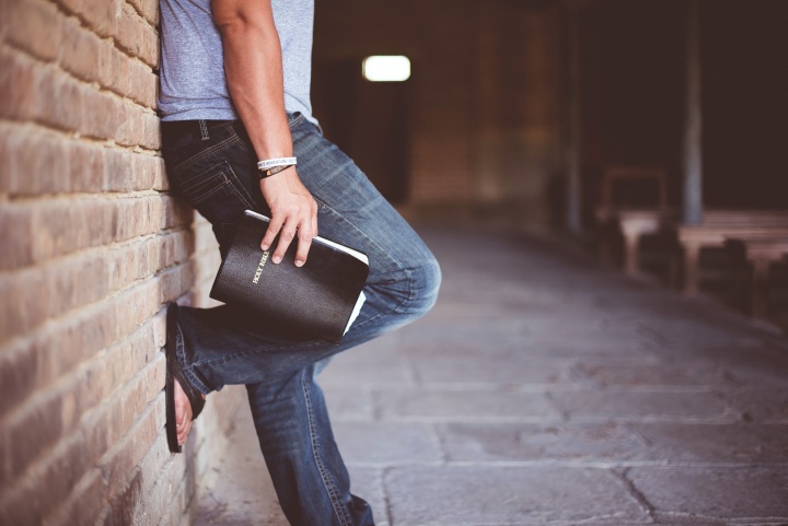 Man holding Bible.