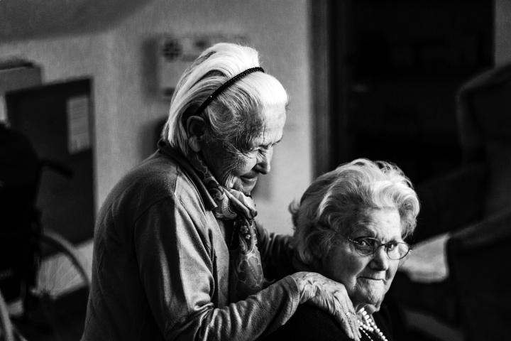 Two elderly women beside each other.