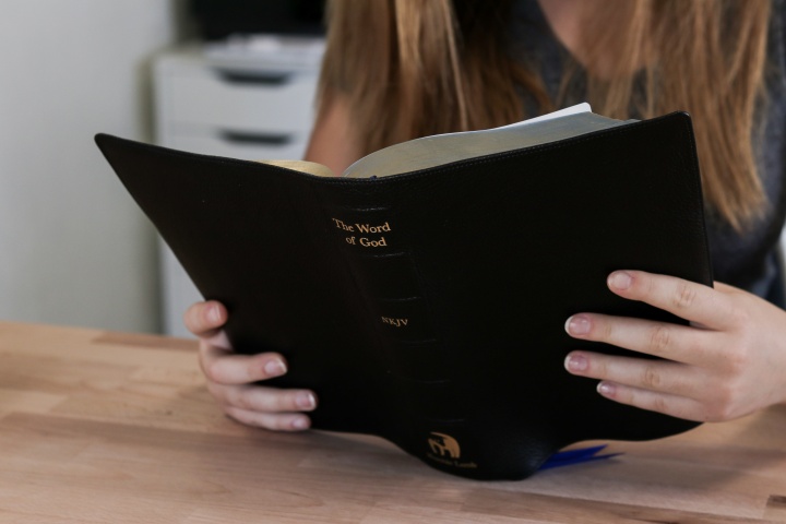 A woman reading a Bible.