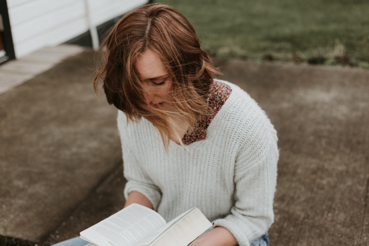 A woman reading a Bible.