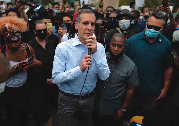 A man speaking to a large crowd.