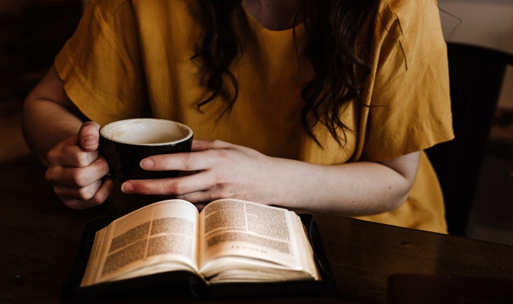 A woman reading a Bible.