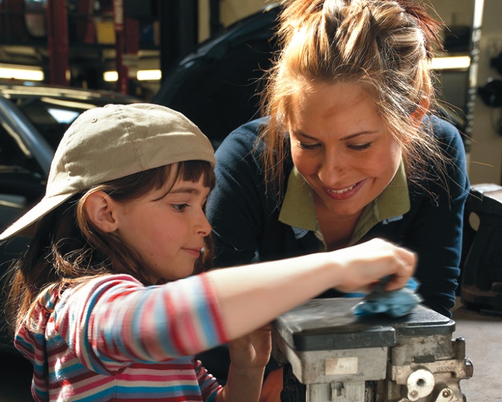 A mother and daughter working together on a project.