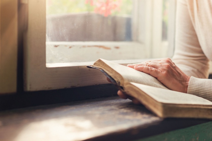 A woman reading a Bible.