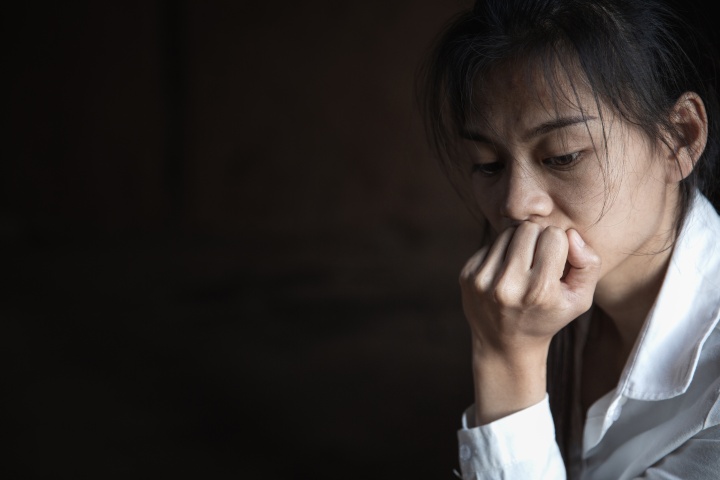 A woman with her chin resting on her hand.