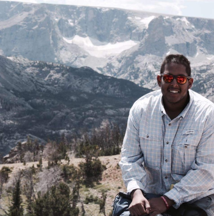 portrait of Jacob Mammen in front of a mountainous backdrop