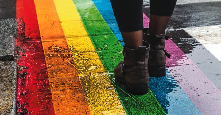 Pride flag color painted on a sidewalk.