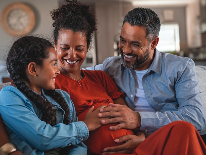 A family sitting together on a couch.