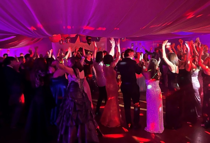 A group of teenagers in formal attire at a dance