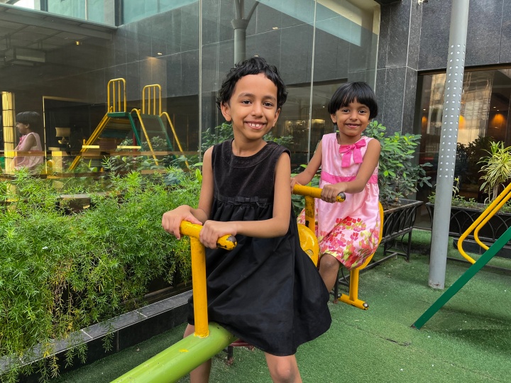 two children enjoying playground equipment