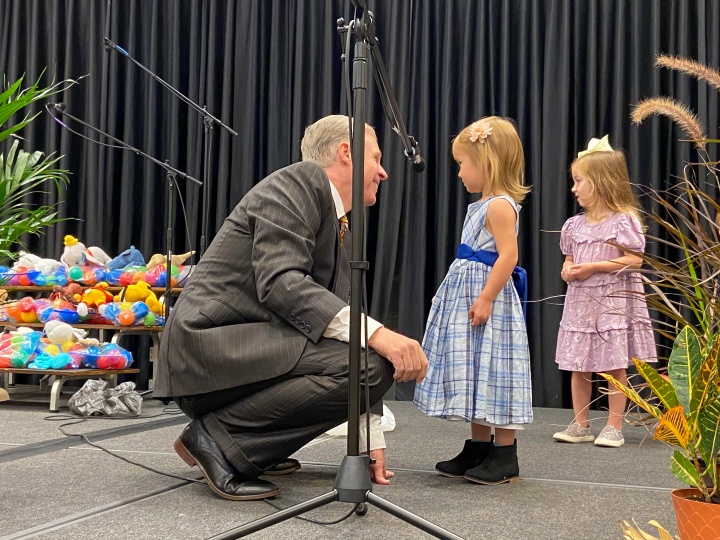 a member speaking with some of the children at the Feast