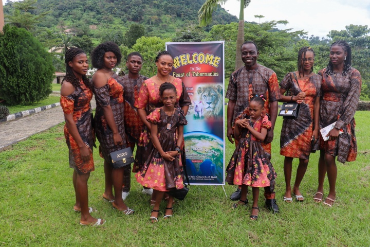 a group of people standing outdoors in front of a banner and wearing coordinating clothing