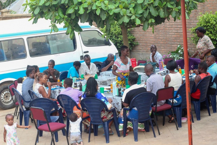 a group of people eating outdoors in front of a van