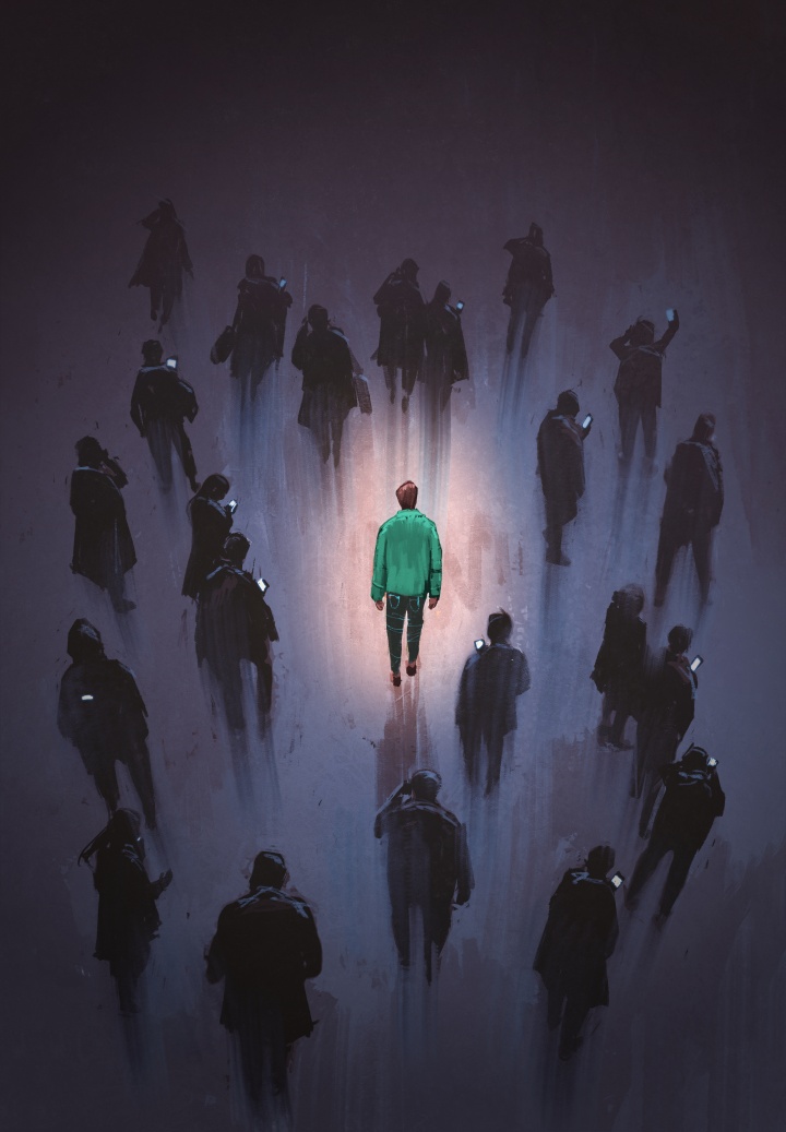 one person glowing amongst a group of darkened figures