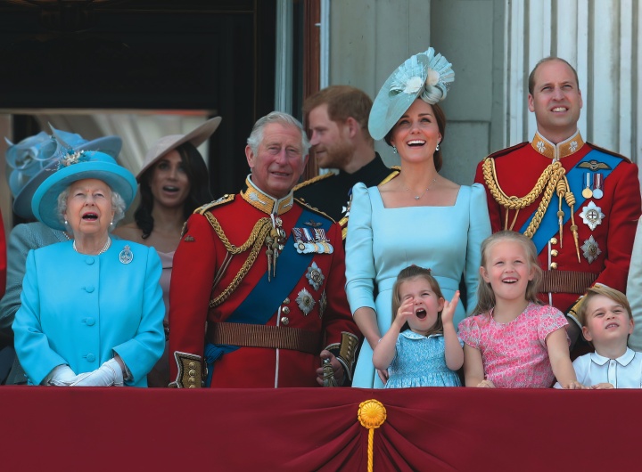 Four generations of Britain’s royal family watch a military flyover at Buckingham Palace.