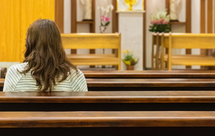 A woman sitting in a church.