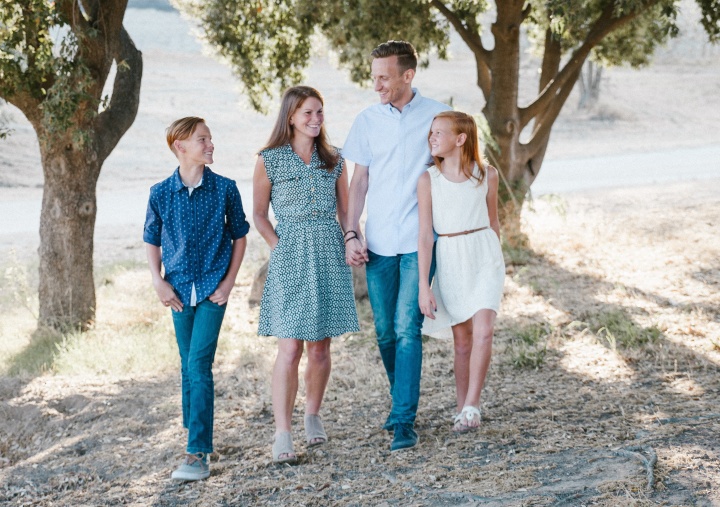 A family walking in the woods.