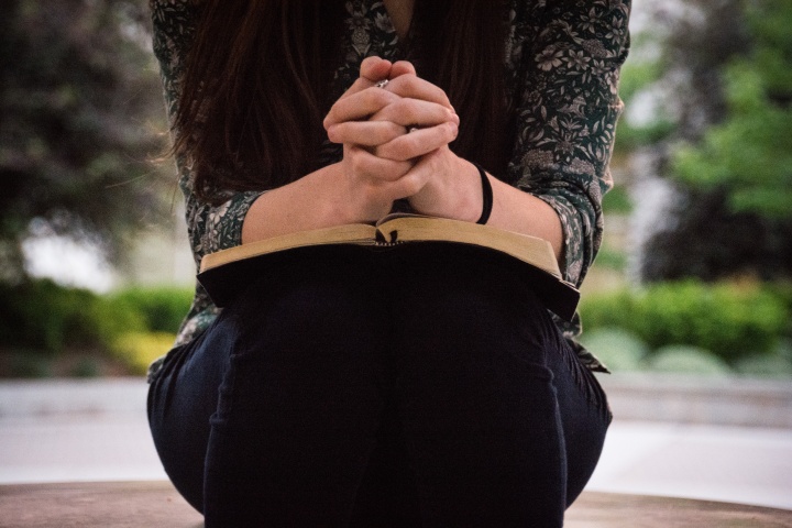 A woman reading a Bible.