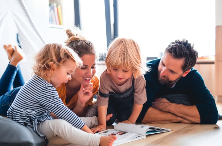 A family looking at a book.