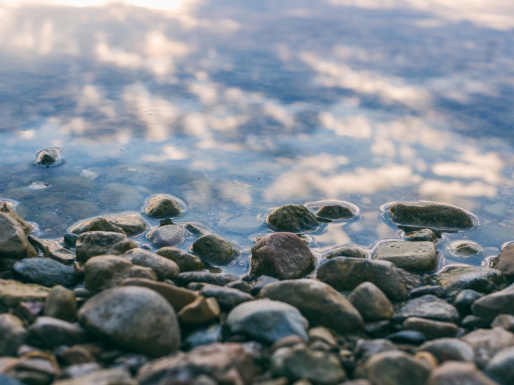 a surface of gray stones slightly covered with water