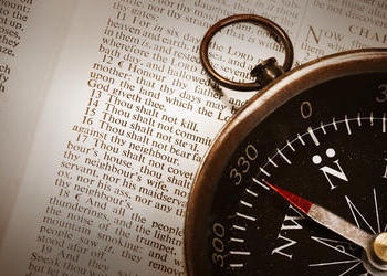 Compass on top of Bible - Showing the Ten Commandments