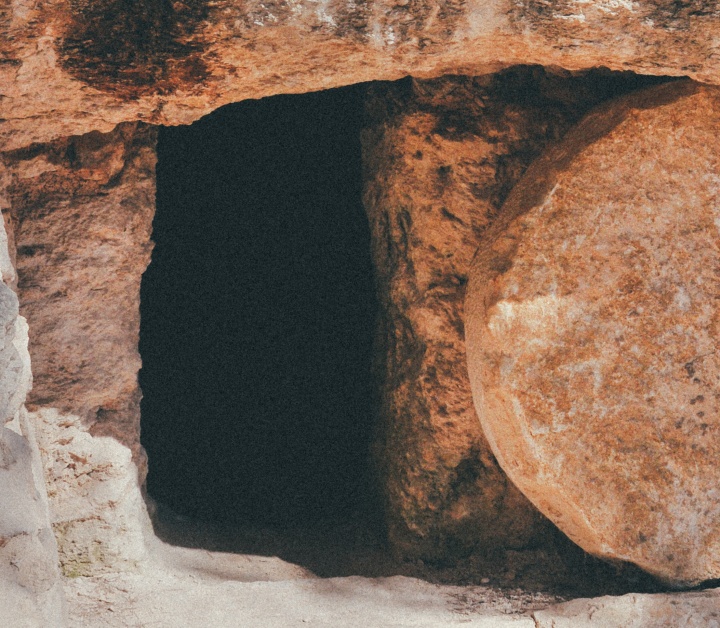 Upclose of a tomb with a round stone.