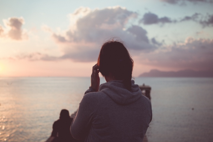 A young woman looking at water.