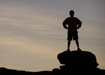 boy standing on a rock