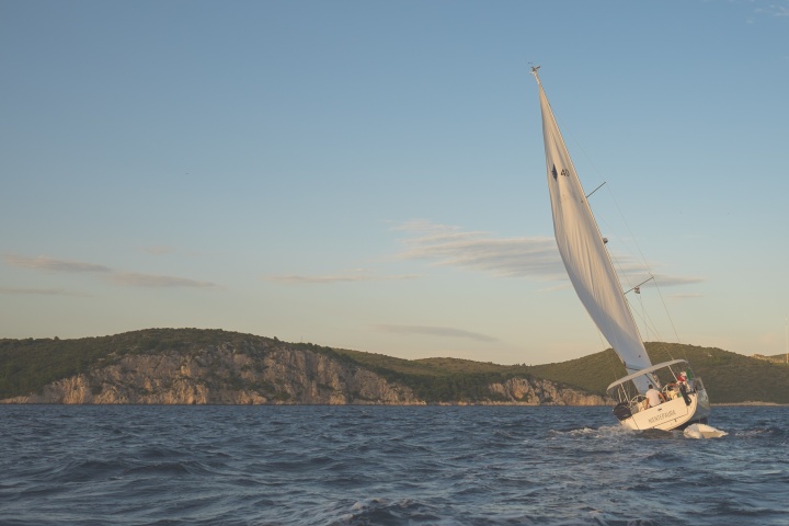 A sailboat leaning into the wind.