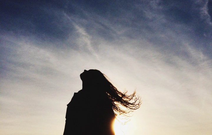 A woman looking up to the sky.