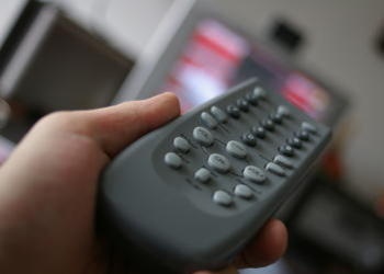 hand holding a television remote control