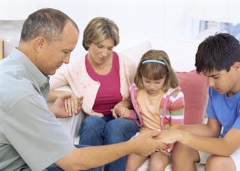 A family praying together.