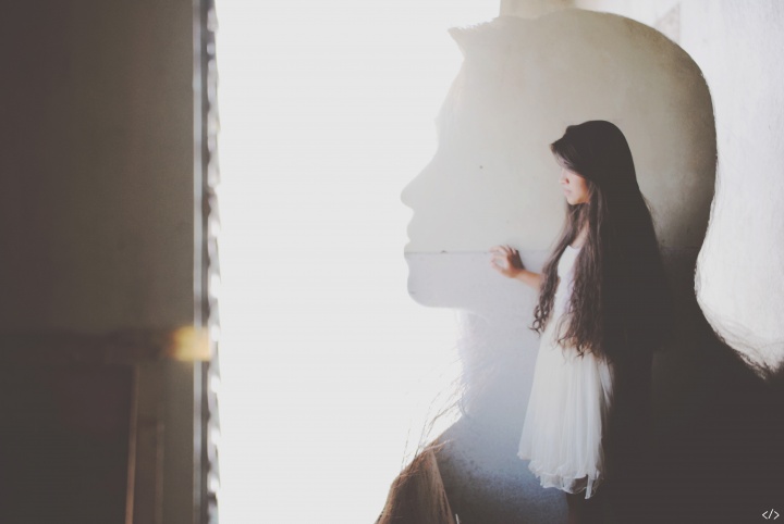 The silhouette of a young woman.
