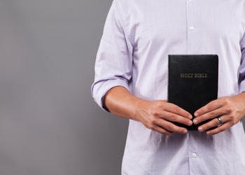 A man holding a Bible.