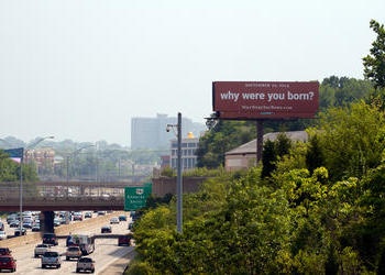 Red "why were you born?" billboard near downtown Cincinnati.
