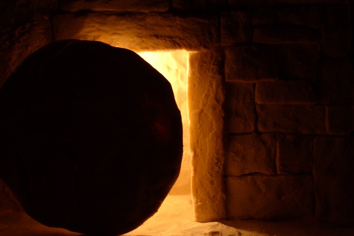 A round stone in front of a tomb entrance.