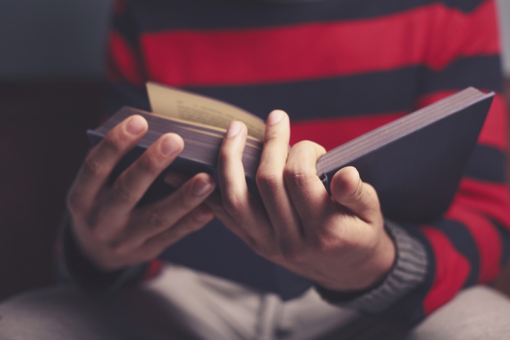 A young man reading a Bible.