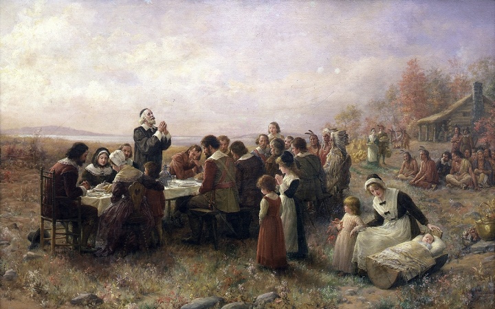 Painting of pilgims giving thanks during a meal.