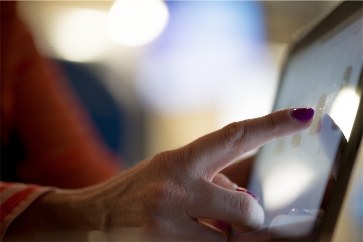 A woman using a touch screen.