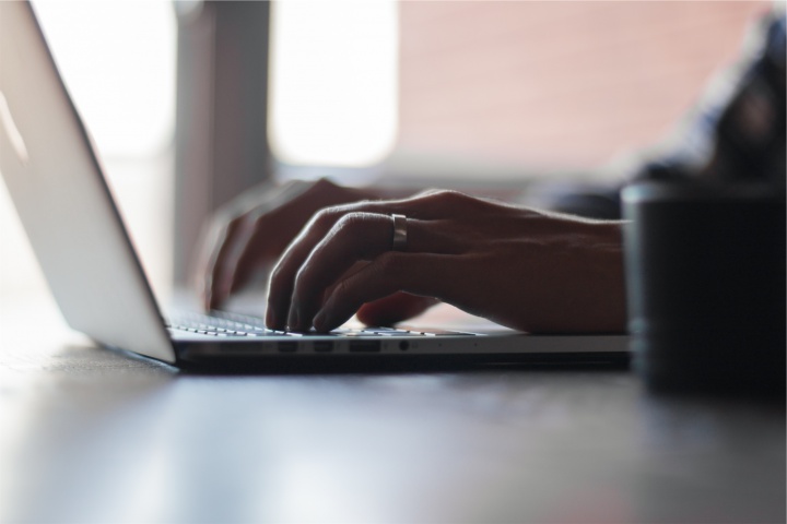 A person typing on a laptop.