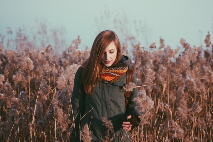 A woman standing in a field of flowers.