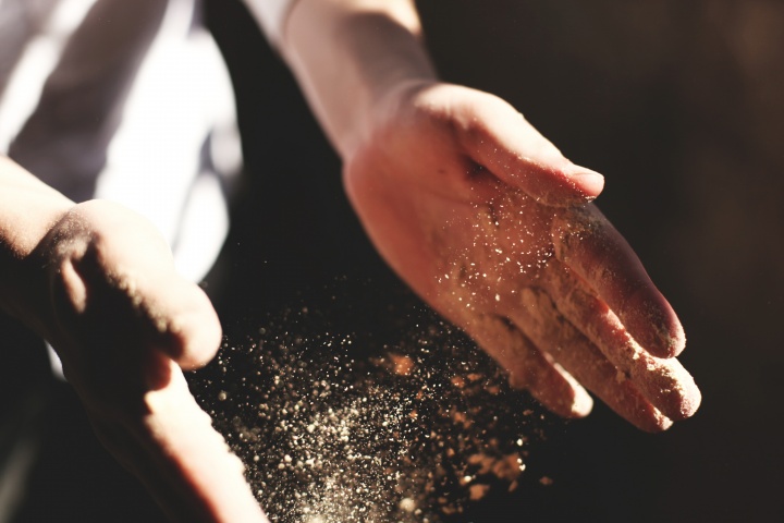 Dust falling out of hands.