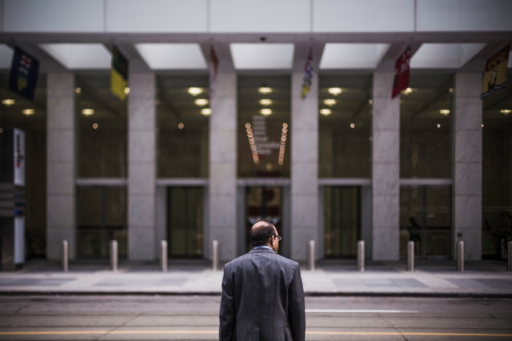 A man across from a big building.