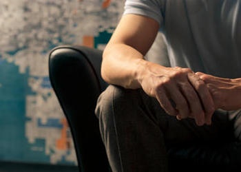 Man sitting in leather chair.