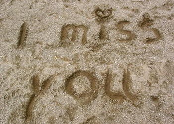 words I miss you written in sand