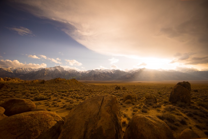 A high plains desert with snow capped mountains in the distance.